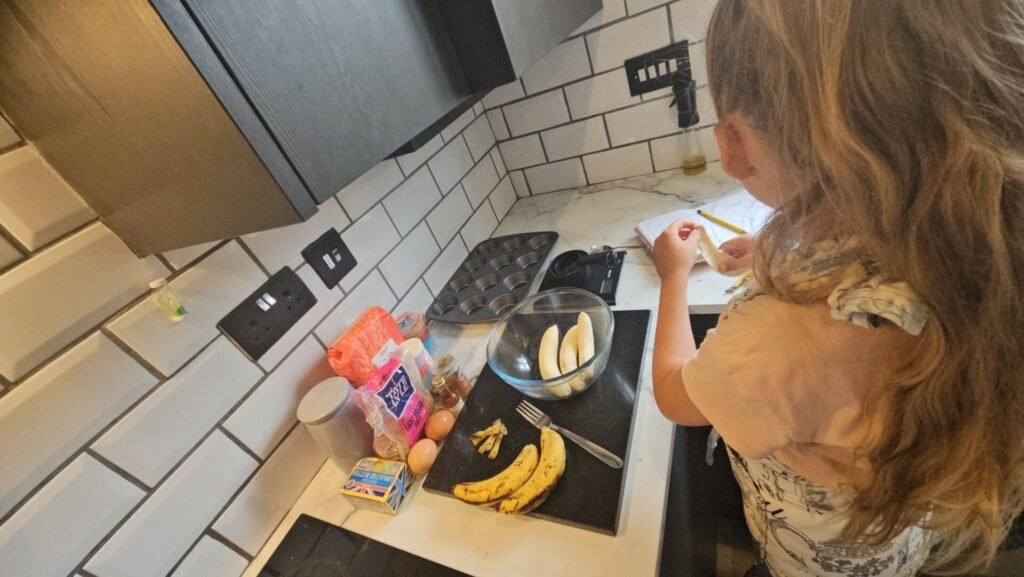image of girl peeling bananas into bowl, making cakes
