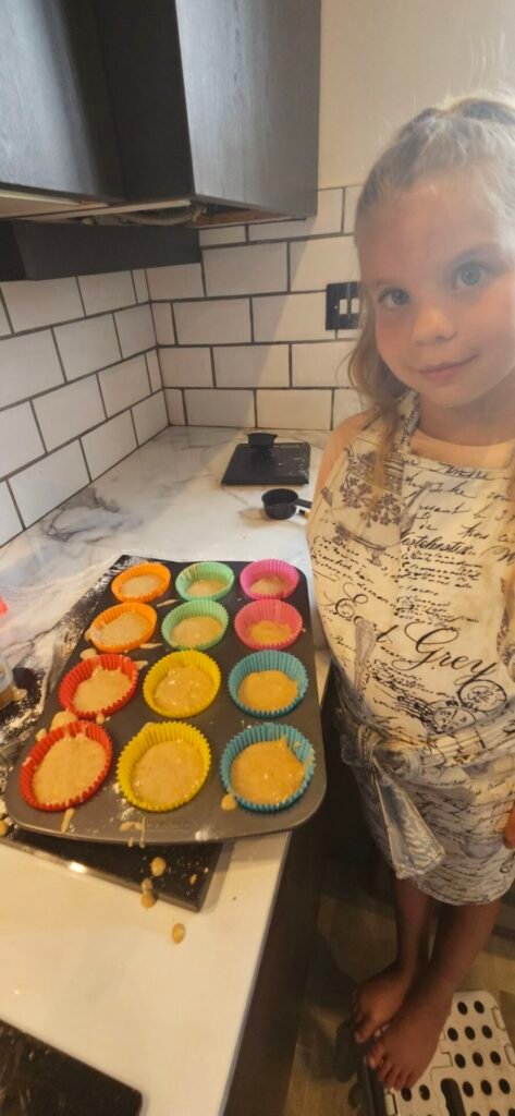 image of girl with cake mixture in cake tin
