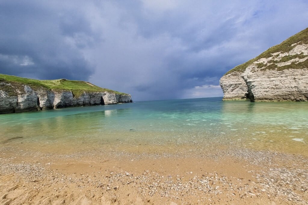 Image of cove beach surrounded by rocky cliffs