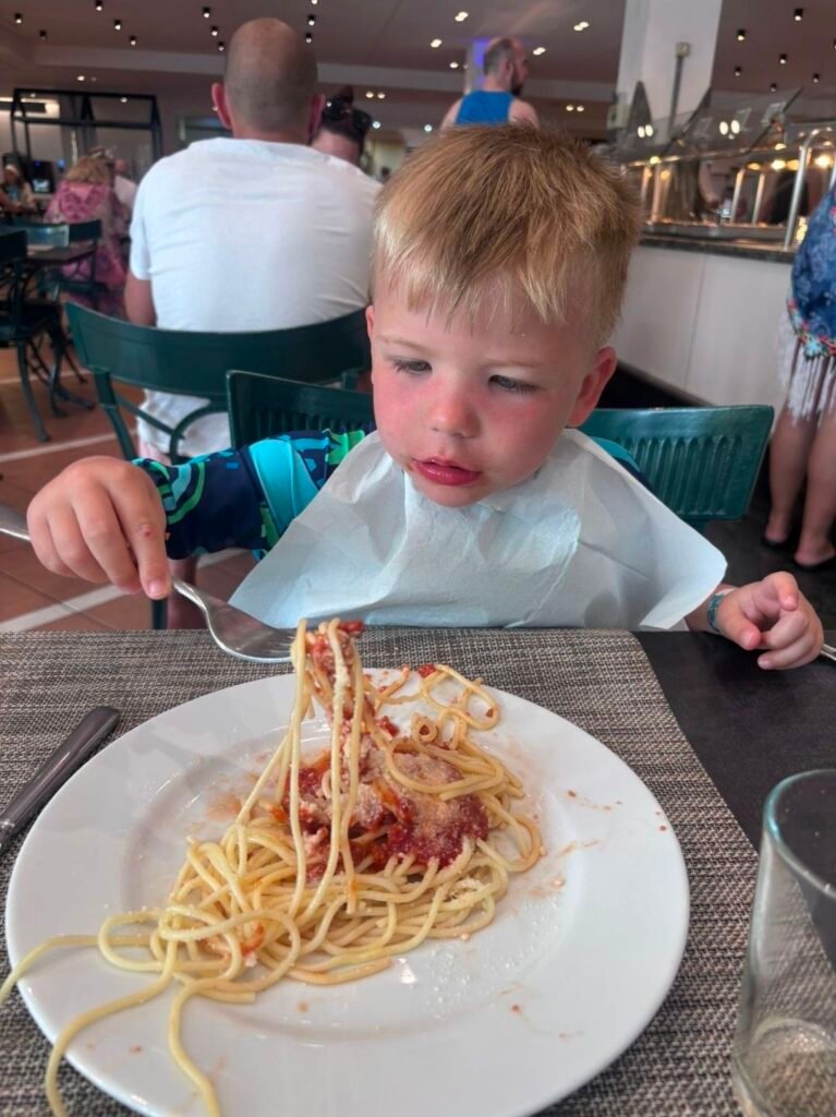 image of boy eating spagetti