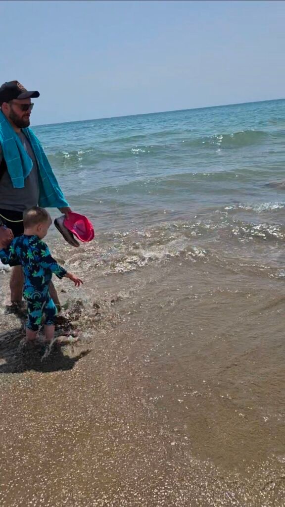 image of boy and dad walking on the beach
