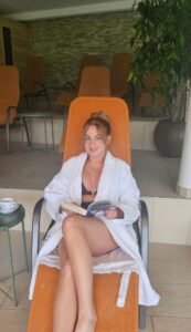 Jen relaxing in a white robe on a spa lounger at Hotel Spirodom
