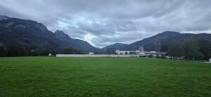 Cloudy evening sky over the mountains and green fields in Admont, Austria