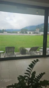 Spa loungers beside a window overlooking green fields and mountains in Admont